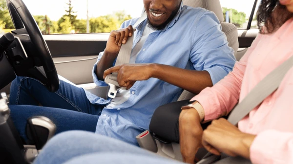 A family driving safely in a car representing security and savings
